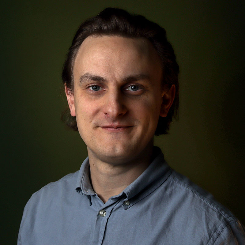 Phil is a white man with longish dark blonde hair